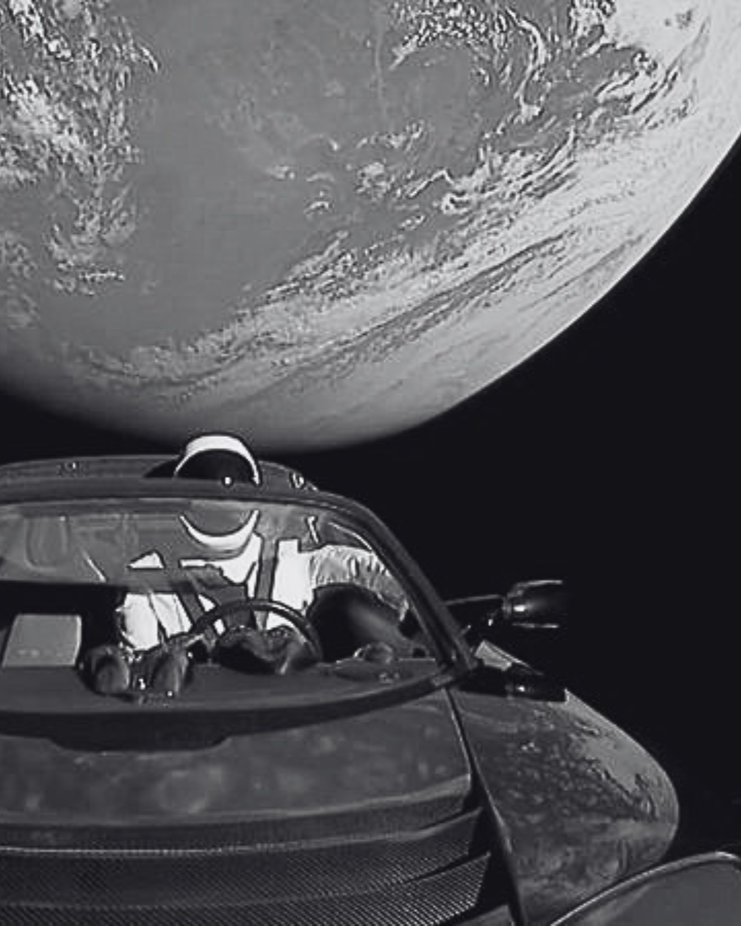 Elon Musk's Tesla Roadster in space with Earth in the background.
